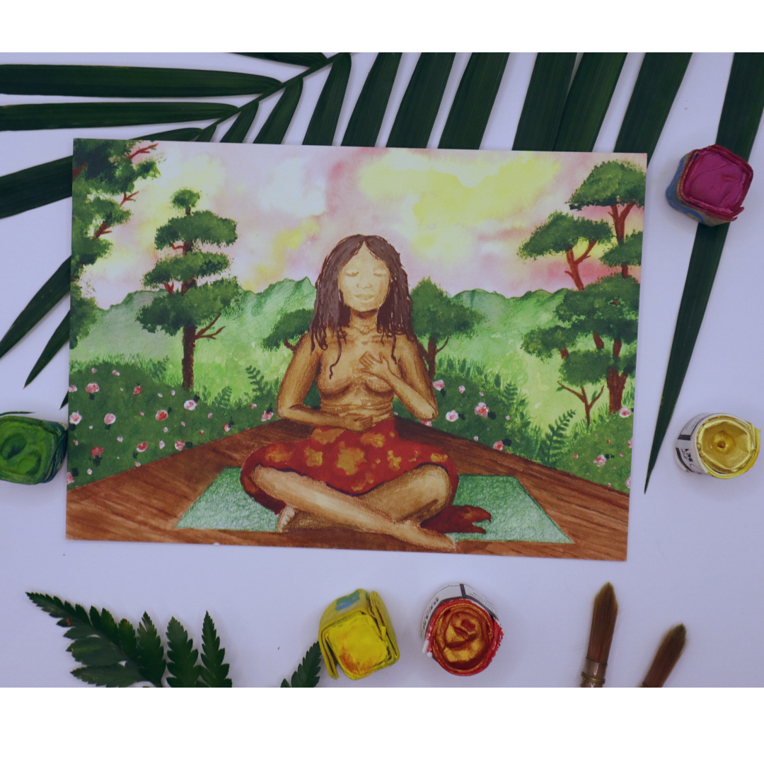 Filipino woman holding her stomach with belly rolls and heart with her eyes closed and legs crossed on a yoga mat on a wooden floor with mountaines, rainforest, and a sunset behind