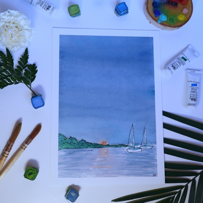 Photo of a Harvest moon cusping the horizon by the Pacific Oceans seascape painting. Print surrounded by art supplies, watercolour palette, paintbrush, and greener and flowers.